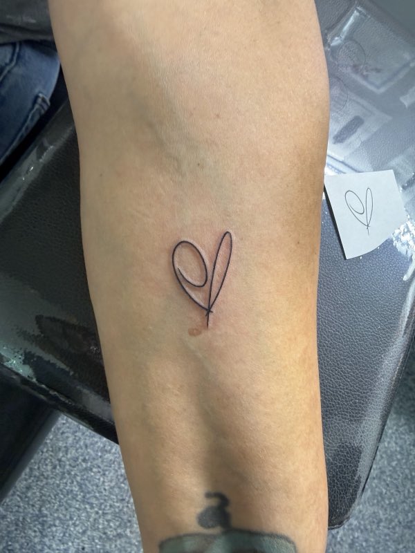 Minimal heart-ribbon forearm tattoo (owner-posted)