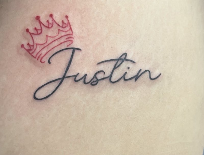Name script tattoo with red crown detail (owner-posted)