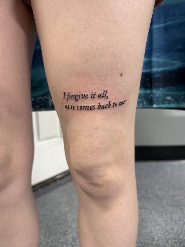 Script quote tattoo above the knee (owner-posted)